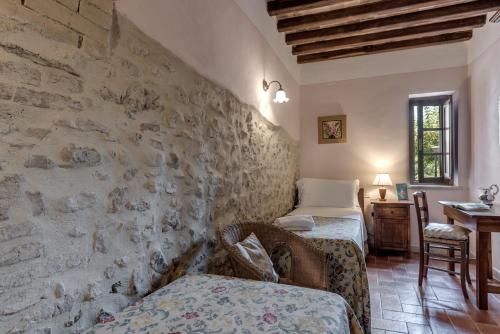 Ένα ή περισσότερα κρεβάτια σε δωμάτιο στο Borgo Al Cerro