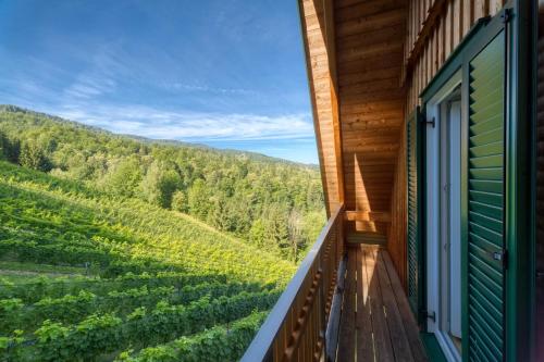 a balcony with a view of a vineyard at Ferienhaus Wagnerfranzl in Eibiswald