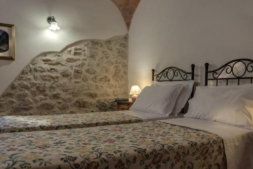 Ένα ή περισσότερα κρεβάτια σε δωμάτιο στο Borgo Al Cerro