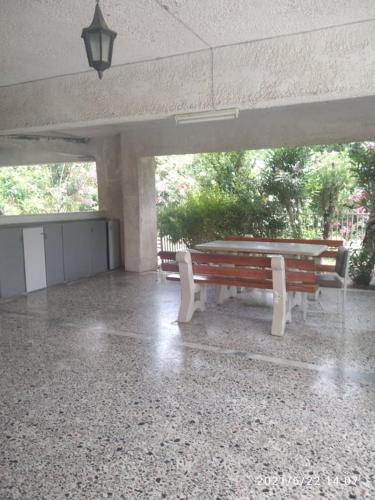 two park benches in a pavilion with a light at Little Beauty - HappyHostGr - in Platamonas in Platamonas