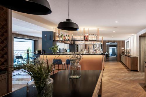 a bar with a table and chairs in a room at Linder Cycling Hotel in Selva di Val Gardena