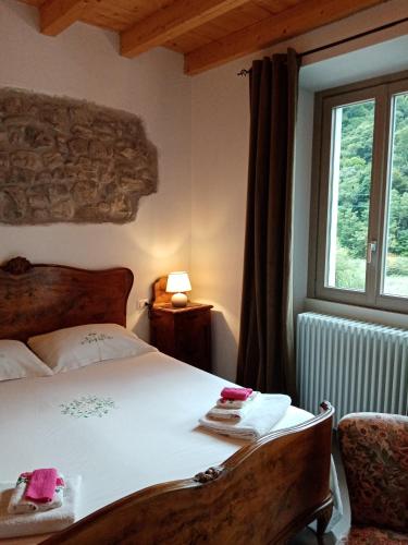 a bedroom with a bed and a window at B&B La Corte del Segrino in Canzo