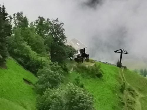 a house on top of a green hill at Ögghof 222 in Kaunertal