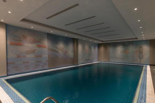 a swimming pool in a hotel room with a swimming pool at Gardino Hotel & Residence in Riyadh