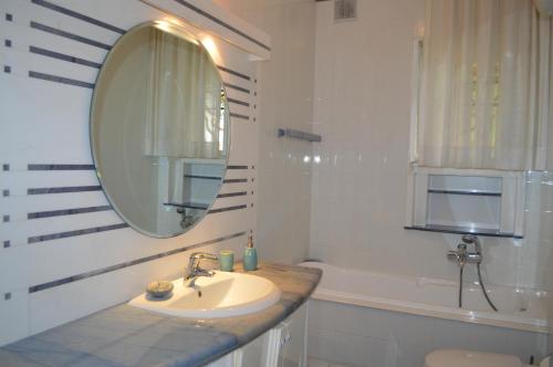 un bagno con un lavandino, uno specchio e una vasca di Gallipoli Apartment ActiveLife a Gallipoli