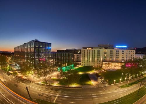 a city at night with buildings and street lights at Hotel Stadt Freiburg in Freiburg im Breisgau