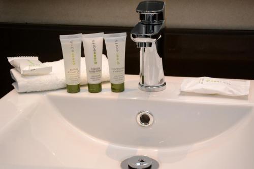 a white sink with a faucet on top of it at Premier Hotel Quatermain in Johannesburg