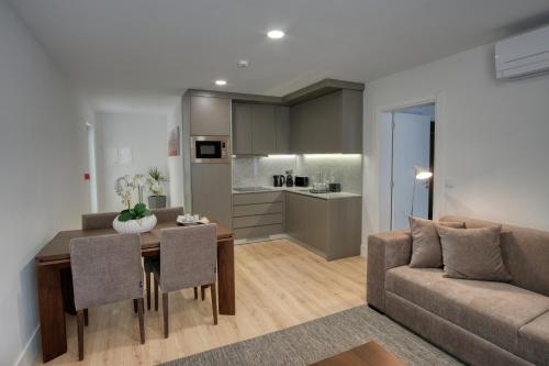 a living room and kitchen with a table and a couch at Quinta da Mourinha in Arcos de Valdevez