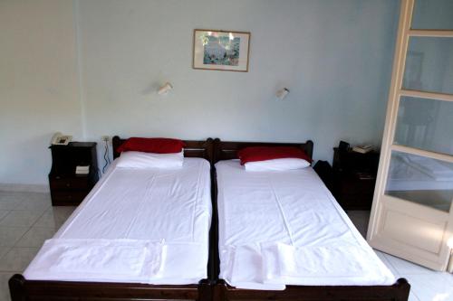two beds sitting next to each other in a room at Apraos Bay Hotel In Kalamaki Beach- a peaceful area with great sea view in Apraos