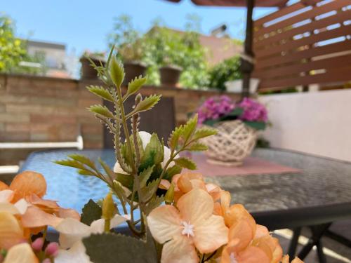 a table with a bunch of flowers on it at Irini Apartments in Kavala