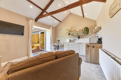 a living room with a couch and a kitchen at Host & Stay - The Pepper Pot in Alnwick