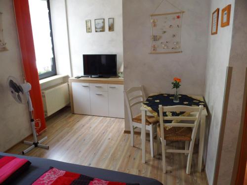 a small kitchen and dining room with a table and chairs at Hotel Restaurant Zum Valwiger Herrenberg in Valwig