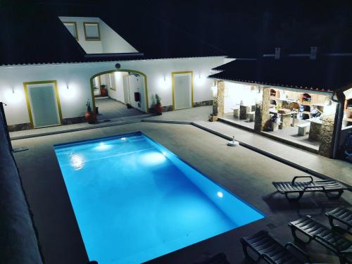 a swimming pool in a house at night at Casinhas da Avó Aura in Reguengos de Monsaraz