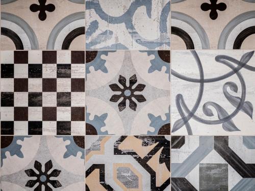 a collage of different types of tiles on a wall at Hotel Lory in Forlì