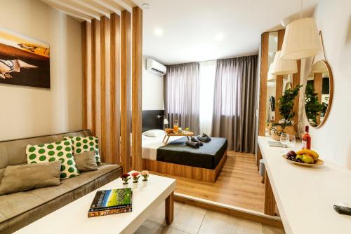 a living room with a bed and a couch at Unique Experience Apartment’s in Thessaloniki