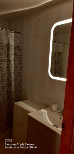 a bathroom with a sink and a shower curtain at Tomillaron House in Las Rozas de Madrid