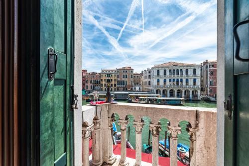 a view of a city from a balcony at Royal Rialto Apartment - Grand Canal View in Venice