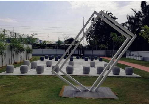 a sculpture of a frame on a grass field at 聚乐屋民宿Jyuraku homestay The venus sitiawan in Sitiawan