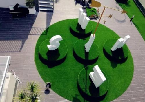 a circle of green grass with white objects on it at 聚乐屋民宿Jyuraku homestay The venus sitiawan in Sitiawan