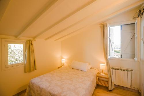 a small bedroom with a bed and a window at CASA LAS OLAS DE LANGRE in Langre