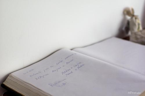 a book with handwriting on it sitting on a shelf at Apartments and Rooms Degra in Umag