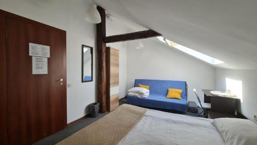 a bedroom with a blue bed and a desk at Makarov Hostel in Moscow