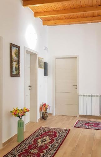 a living room with a door and a rug at Villa Goliku in Peshtan
