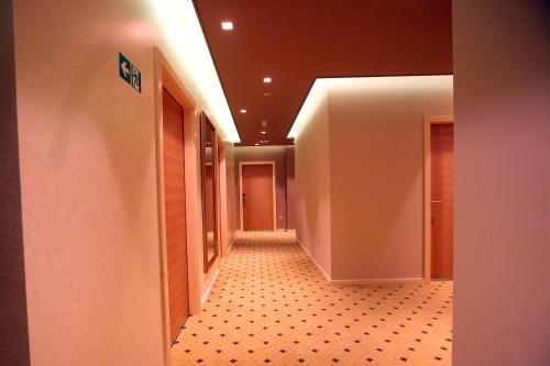 a hallway of an office building with a tile floor at Hotel Gallus in Sesvete