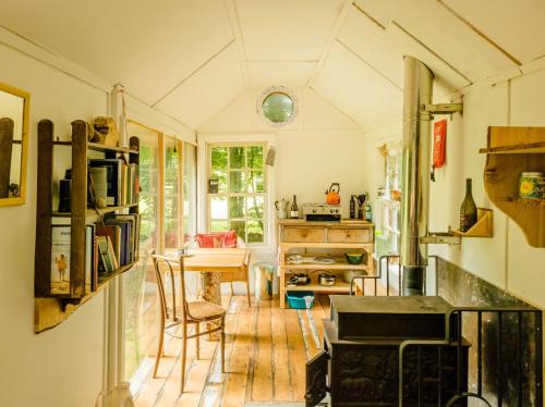 a kitchen with a table and a dining room at Bamff Ecotourism in Alyth