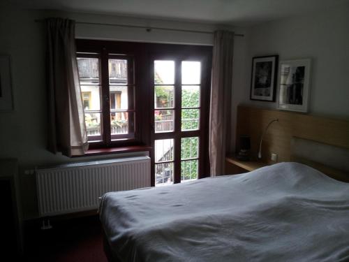 um quarto com uma cama e uma grande janela em Gesundheitshaus Hohnstein em Hohnstein