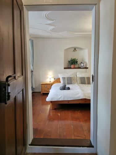 a bedroom with a white bed with a wooden floor at Flyns in Görlitz