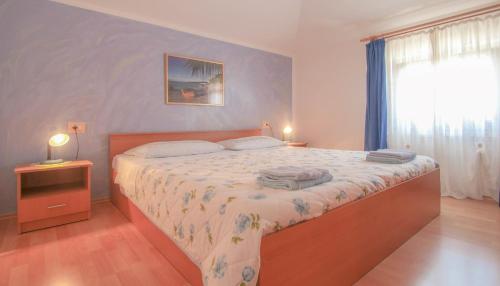 a bedroom with a large bed and a window at Bruno in Umag
