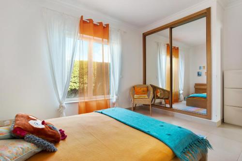 a bedroom with a bed and a large mirror at Villa Carrapateira in Carrapateira