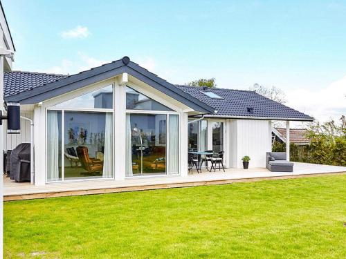an extension of a house with large windows and green grass at 7 person holiday home in Slagelse in Slagelse