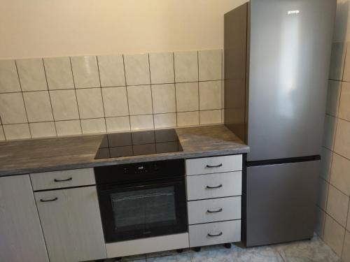 a kitchen with a stove and a refrigerator at Apartments Veni Up in Starigrad