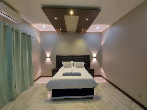 a bedroom with a large bed in a room at WHITE SHARK RESORT in Ponta do Ouro
