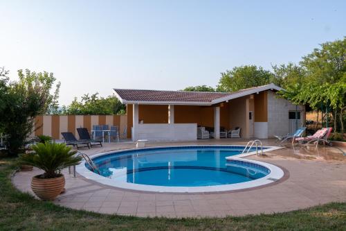 a swimming pool in front of a house at Villa Cesar in Mostar
