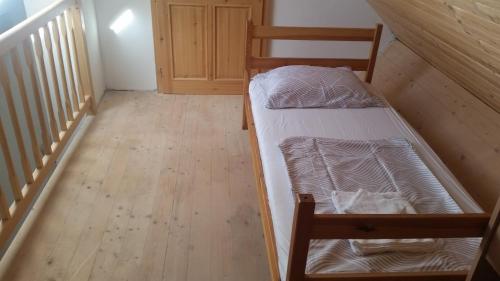 a small room with a bunk bed and a staircase at Holiday country house Gora in Gozd