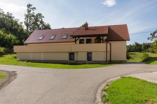 a house with a red roof on a road at Holiday country house Gora in Gozd