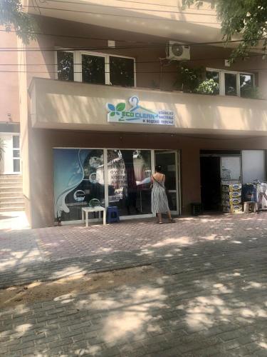 a woman standing in front of a building at Centre apartment in Prilep