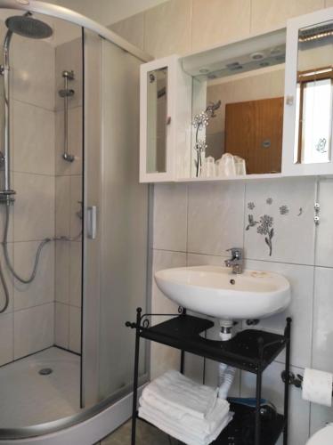 a bathroom with a sink and a shower at Apartments 4M in Kostrena