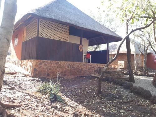 a building with a stone wall in front of it at ThabaNkwe Bushveld Inn in Thabazimbi