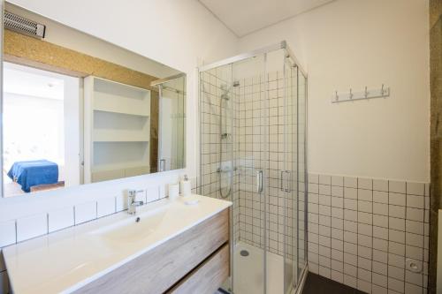 a bathroom with a sink and a shower at Linden Tree House A and B in Caldelas