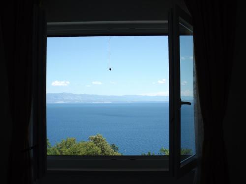 a window with a view of the ocean at Apartments Villa Elma in Mošćenička Draga