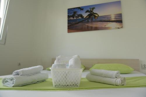 a pile of towels and towels on a table at Apartments Villa Naumovi in Star Dojran