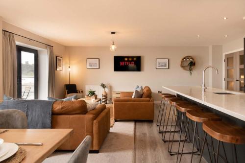 a kitchen and living room with a couch and a bar at The Sands Sea Front Apartments in Scarborough