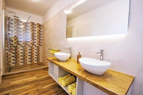 a bathroom with two sinks and a shower at New Villa with Pool in Barbariga