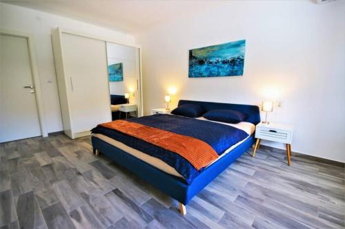a bedroom with a blue bed in a room at New Villa with Pool in Barbariga