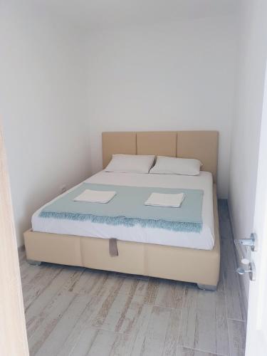 a bed in a room with a wooden floor at Apartment Jovana in Igalo