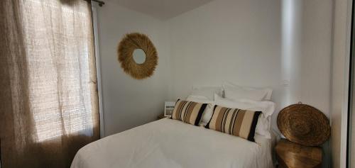 Schlafzimmer mit einem Bett und einem Spiegel an der Wand in der Unterkunft Petit Cocon in La Croix-Valmer